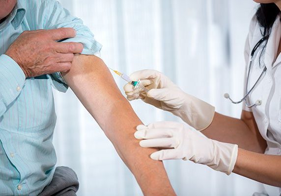 Vaccinating An Elderly Person Vaccinating An Elderly Person